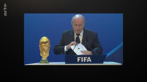 Sepp Blatter, ancien président de la FIFA, s'exprime lors d'une conférence de presse officielle avec le trophée de la Coupe du monde de football à ses côtés.