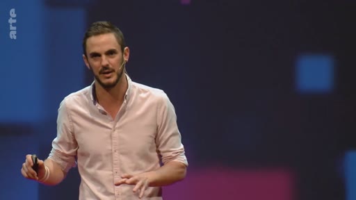 Un présentateur masculin s'exprime devant un public lors d'une conférence sur le climat, utilisant un pointeur laser pour illustrer ses propos.