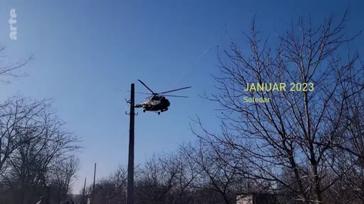 Un hélicoptère militaire survole une zone boisée à Soledar en janvier 2023, dans le contexte du conflit en Ukraine.