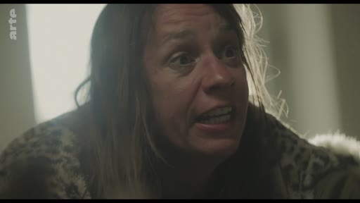 Une femme au visage marqué par une vive émotion, probablement en pleine dispute domestique, est filmée en gros plan. L'image capture une expression intense et dramatique, typique d'une scène de fiction ou d'un documentaire social.